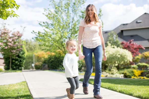 Daughter and mom walking through the neighborhood near Ardendale Apartments