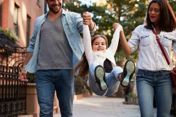 Family walking through the neighborhood near Sunridge Apartments in Fair Oaks, CA