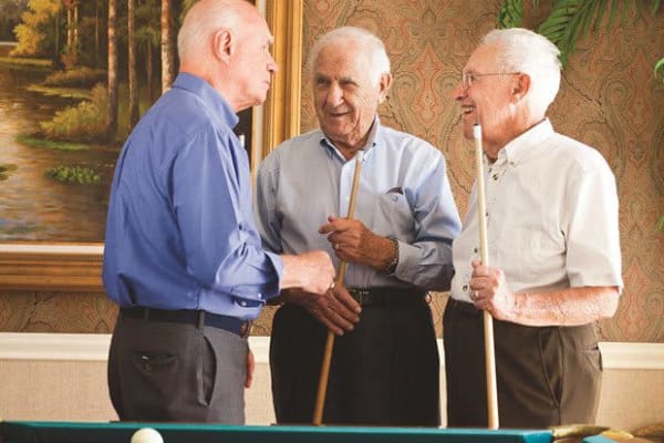 Men playing pool at Country Club At Woodland Hills in Tulsa