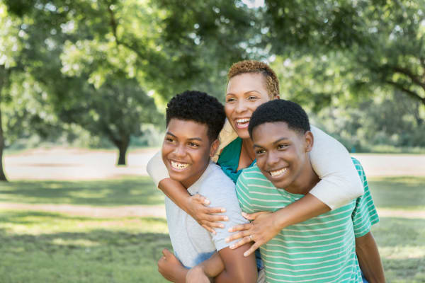 Mother and sons walking through the neighborhood near El Camino Patio Apartments