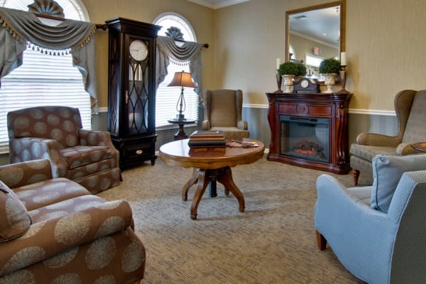 Community lounge with fireside seating at Alexandria Place in Jackson, Tennessee