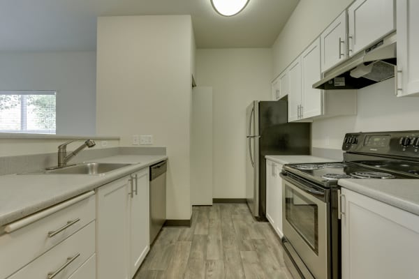 Fully equipped kitchen with stainless steel appliances at The Landings at Morrison Apartments in Gresham