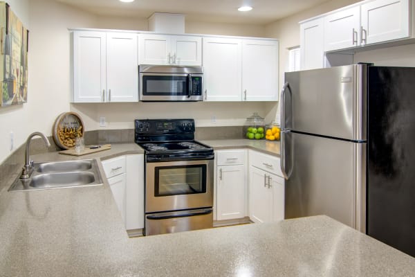 white renovated kitchen with stainless steel appliances at The Addison Apartments in Vancouver