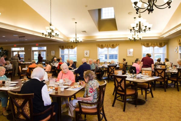 Resident sharing a meal with a friends at Traditions of Hershey in Palmyra, Pennsylvania