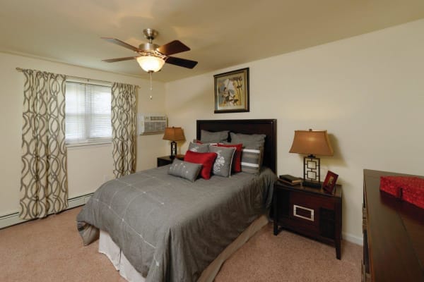 Furnished master bedroom at Hill Brook Place Apartments in Bensalem, Pennsylvania