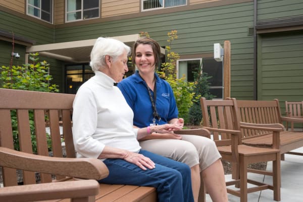 A caretaker sitting with a resident at Touchmark at Mount Bachelor Village in Bend, Oregon