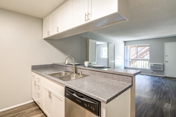 white renovation kitchen with stainless steel appliances at Hillside Terrace Apartments in Lemon Grove