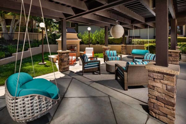 Seating around the fireplace next to the pool at Colonnade at Sycamore Highlands in Riverside, California