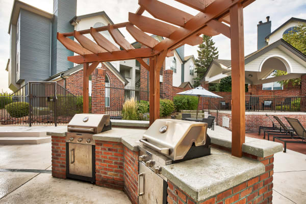 Outdoor community space with grill at Keystone Apartments in Northglenn, Colorado