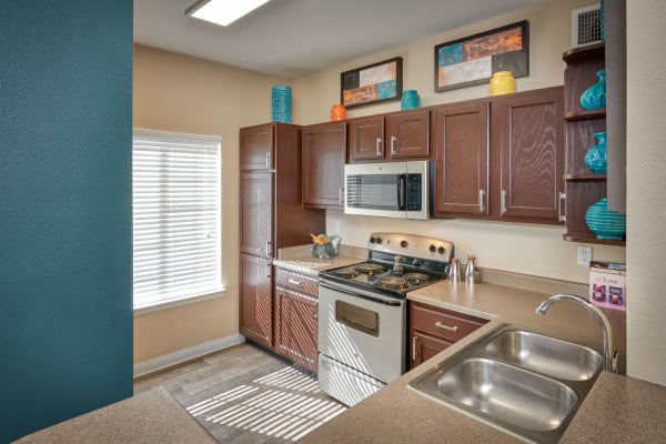 Renovated brown cabinetry model kitchen at Skyecrest Apartments in Lakewood