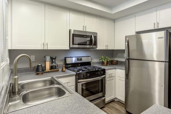 White Renovated Kitchen with stainless steel appliances at Village Oaks in Chino Hills,