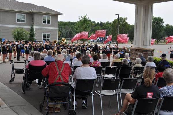 Residents gathered to watch a marching band play at Deephaven Woods in Deephaven, Minnesota