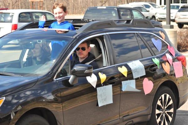 Resident in a car thats covered in decorations at an event for Deephaven Woods in Deephaven, Minnesota