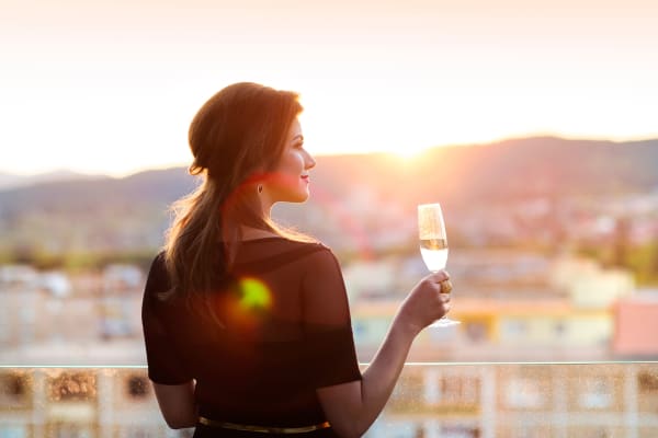Resident admiring the sunset with a glass of wine on a rooftop near Sanctuary on 51st in Laveen, Arizona