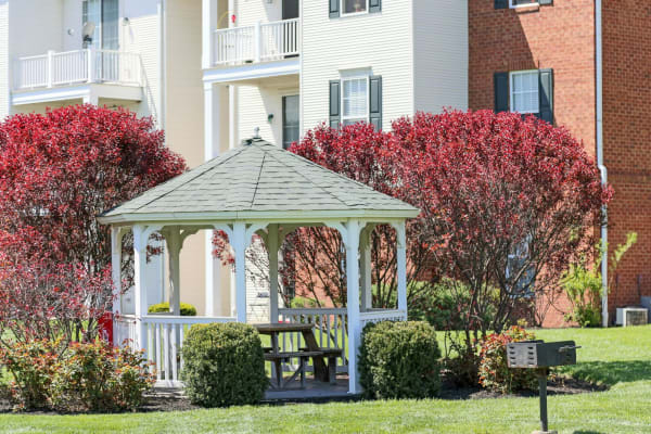 Gazebo with table to sit at and beautiful trees surrounding it at The Preserve at Beckett Ridge Apartments & Townhomes in West Chester, Ohio