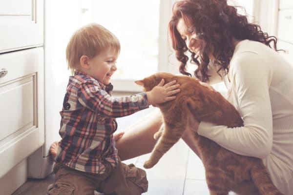 A mom and son with their cat at Trilliam Luxury Apartment Homes in Clanton, Alabama