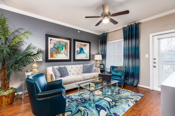 Wide-angle view of model apartment's gorgeously decorated living room at The Abbey at Grande Oaks