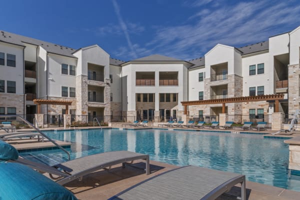 Swimming pool with a large sundeck at McCarty Commons in San Marcos, TX