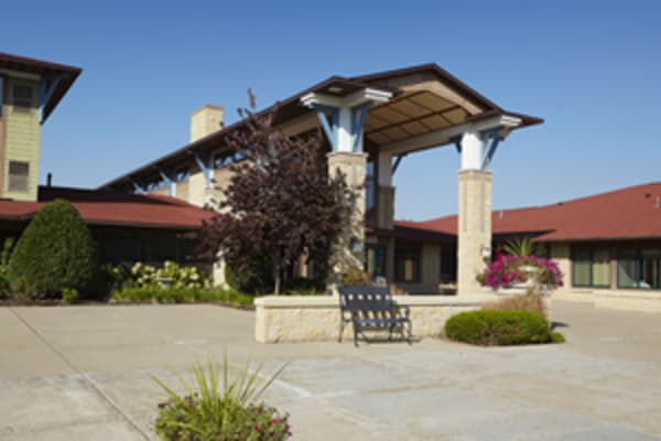 Covered entrance with a large patio at Meadows on Fairview in Wyoming, Minnesota