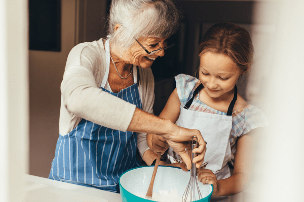 resident baking with her granddaughter at at Wesley Place on Honeysuckle in Dothan, Alabama