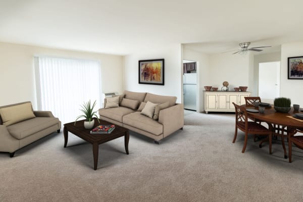 Spacious living room and dining area with plush carpeting in a model apartment home at Brakeley Gardens in Phillipsburg, New Jersey