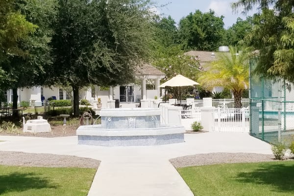 Courtyard with sprawling paved paths and a fountain at Mathison Retirement Community in Panama City, Florida
