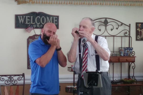 Resident and a caretaker practicing whistling at Mathison Retirement Community in Panama City, Florida