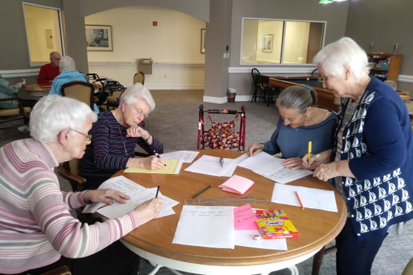 Resident filling out worksheets as a group at Mathison Retirement Community in Panama City, Florida