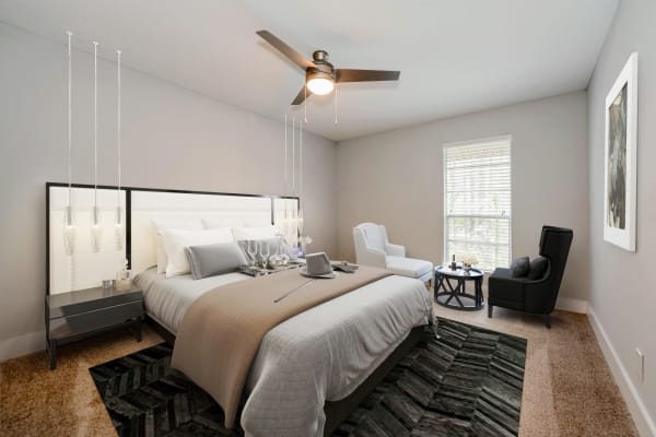 Stunning model bedroom with ceiling fan and unique lighting features at Aria North Hills in Raleigh, North Carolina