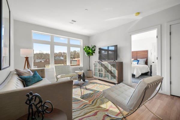 Hardwood flooring and bay windows in a model home's living area at Anden in Weymouth, Massachusetts