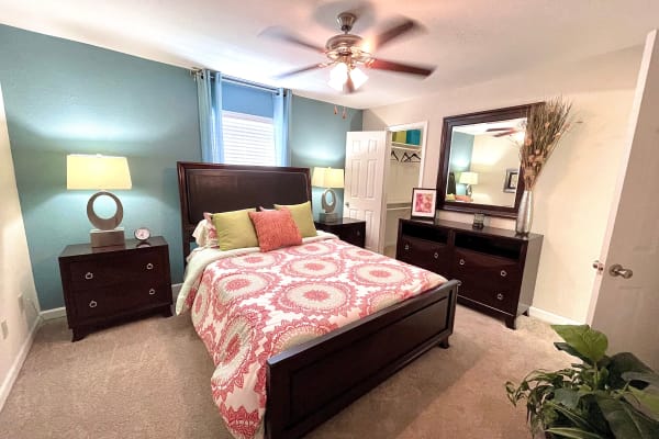 Well decorated bedroom with ceiling fan at The Abbey at Champions in Houston, Texas