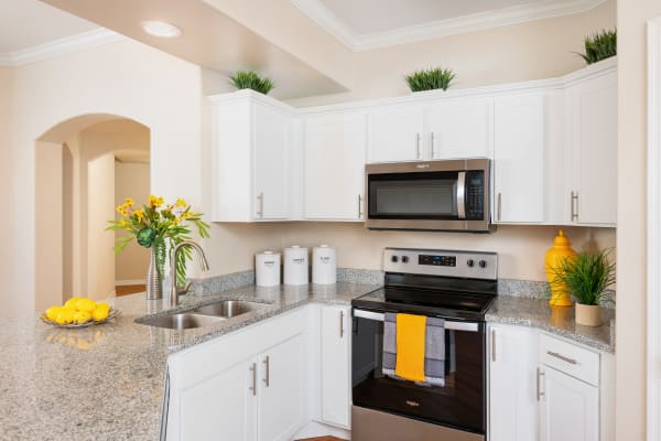 Spacious kitchen with white cabinets an stainless steel appliances at Villas on Hampton Avenue