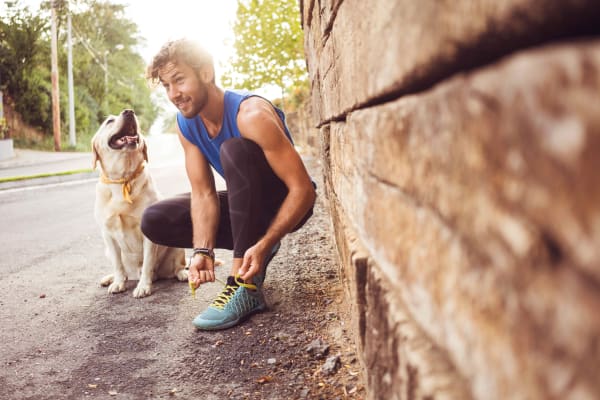 Resident enjoying a walk with his dog near Albion at Murfreesboro in Murfreesboro, Tennessee