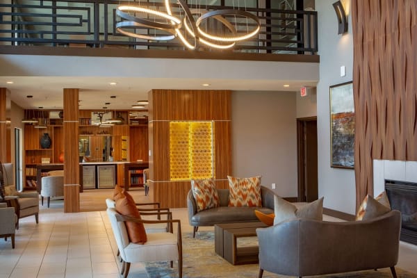 Resident lounge with cozy fireplace at Haven at Lewisville Lake in Lewisville, Texas.