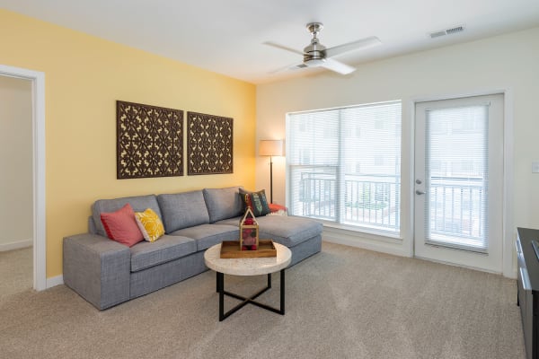Living room with yellow accent wall at Element at Ghent in Norfolk, Virginia