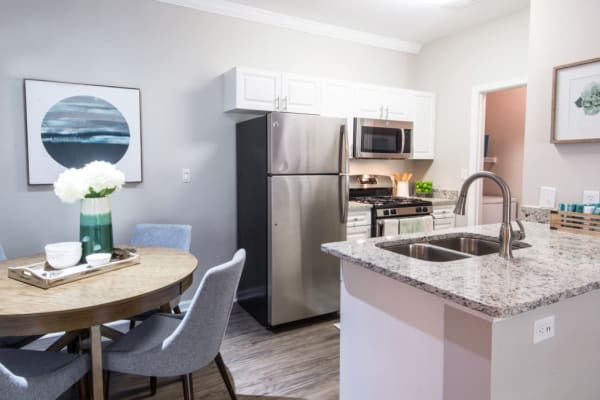 A comfortable, furnished apartment kitchen and dining room at Riverstone at Owings Mills in Owings Mills, Maryland