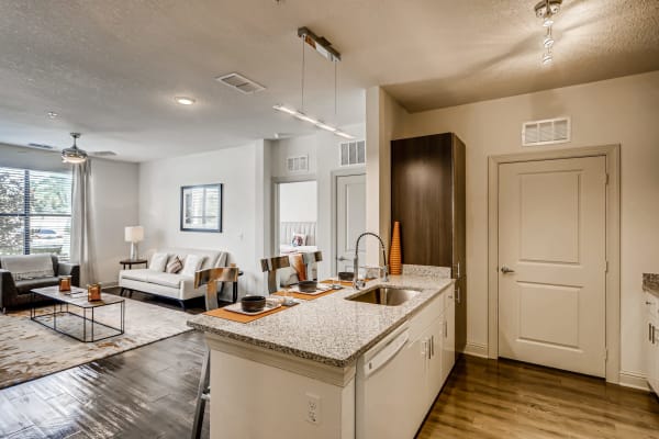 A comfortable, furnished apartment living room and kitchen island at EOS in Orlando, Florida