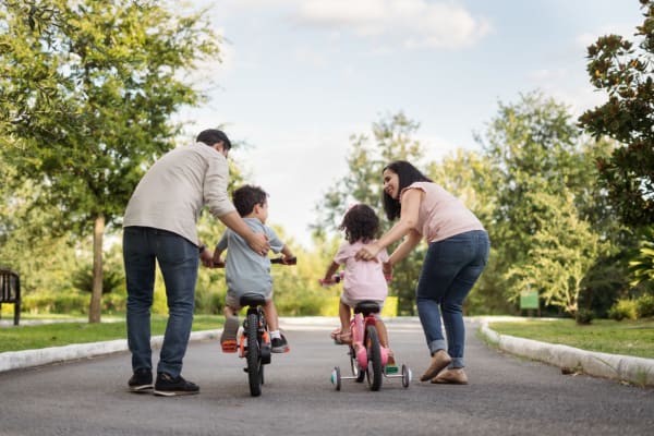 Parents teaching their kids how to bike near Reserves at Northern Woods in Columbus, Ohio