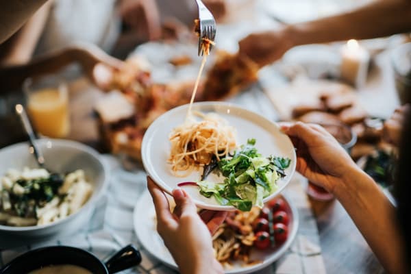 Resident eating a meal with friends at a local restaurant near Hunters Crossing in Newark, Delaware