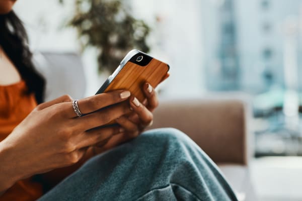 Resident using their phone at Reserves at Tidewater in Norfolk, Virginia