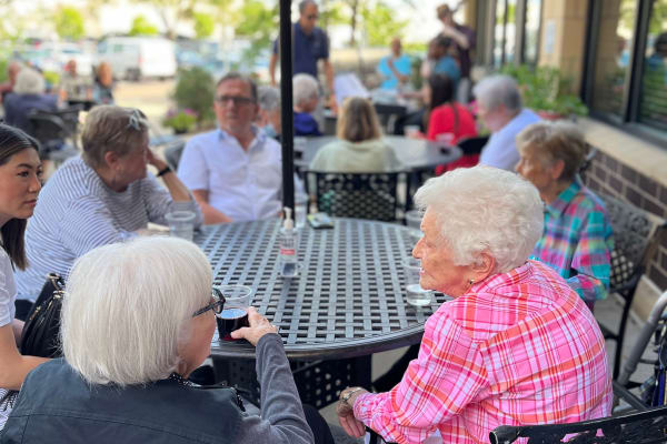 Residents socializing outside at a table at Towerlight in St. Louis Park, Minnesota