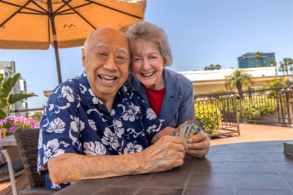 A resident enjoying a mug of coffee outside at Merrill Gardens at Renton Centre in Renton, Washington. 