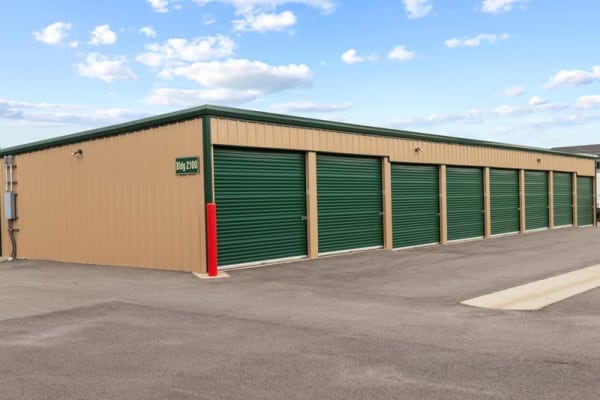 green doors of outdoor units at Storage Near Me - White Oak Storage in North Little Rock, Arkansas