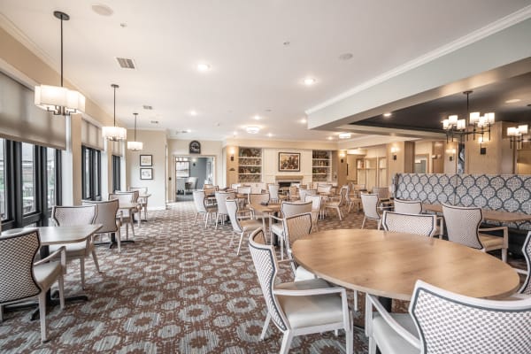 Spacious resident dining hall with lots of seating at The Pillars of Lakeville in Lakeville, Minnesota