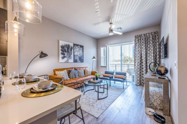 Open-concept kitchen with hardwood-style flooring and espresso wood cabinetry in a model apartment at Jade Apartments in Las Vegas, Nevada