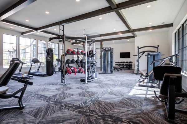 Community gym with weight and cardio machines at The Holston | Apartments in Weaverville, North Carolina