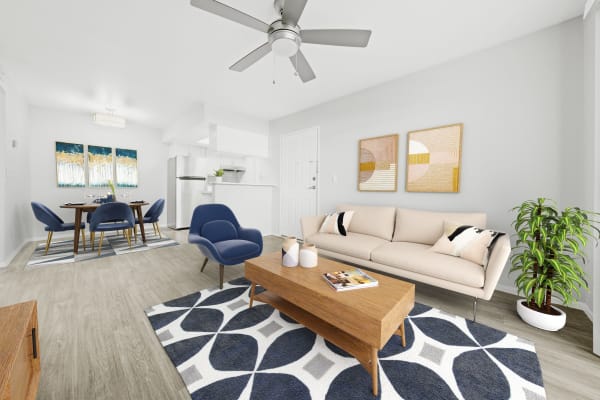 Model living room with a ceiling fan at Connect on Union in Phoenix, Arizona