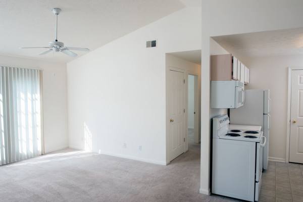 Retro-modern furniture and classic decor in a model home's living area at Victoria Pointe Apartments in Jackson, Michigan