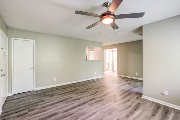 Spacious apartment with hardwood flooring and ceiling fan at Stone Creek in Tampa, Florida