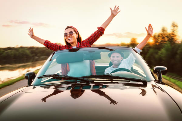 Couple driving in convertible car